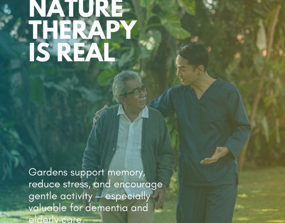 ACGM staff walking with elderly residents through a freshly maintained aged care garden